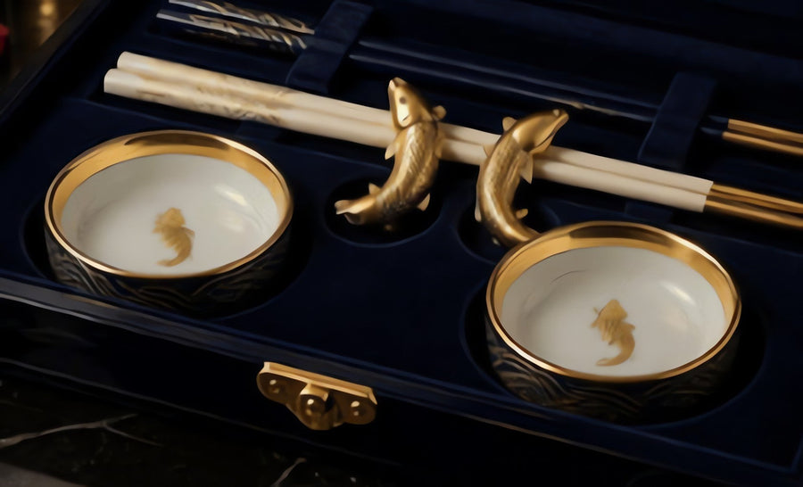 Two round porcelain soy dishes with gold waves